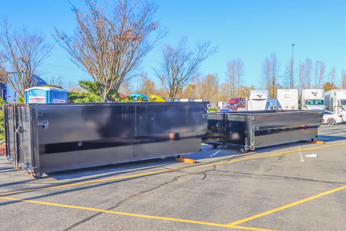 Professional dumpster rental service with roll-off container on residential driveway in Crouch Mesa